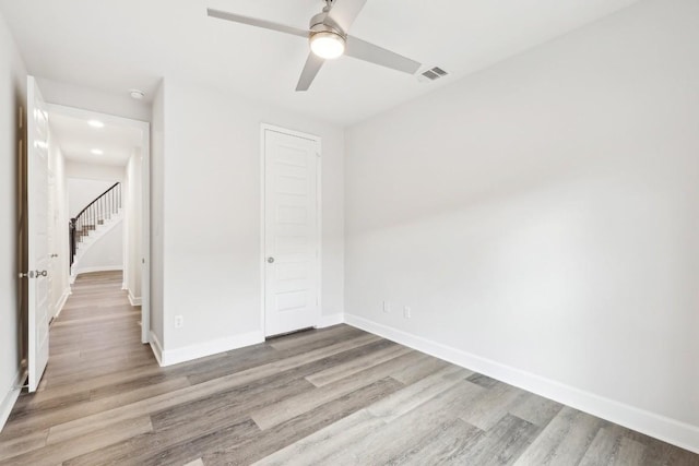 unfurnished bedroom with a closet, ceiling fan, and light wood-type flooring