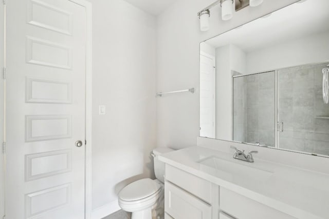 bathroom featuring walk in shower, vanity, and toilet