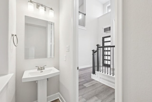 bathroom with hardwood / wood-style flooring and a healthy amount of sunlight