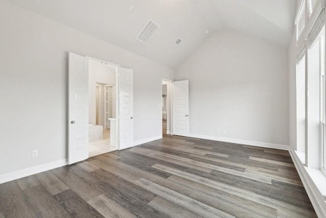 unfurnished bedroom with dark hardwood / wood-style flooring and high vaulted ceiling