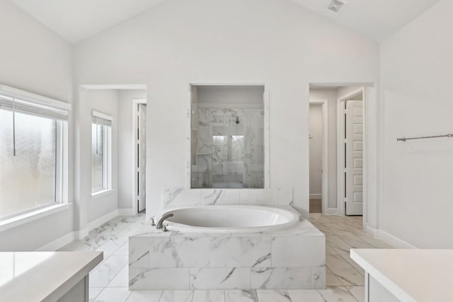 bathroom featuring lofted ceiling, vanity, and plus walk in shower