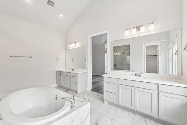 bathroom with vanity, plus walk in shower, and high vaulted ceiling