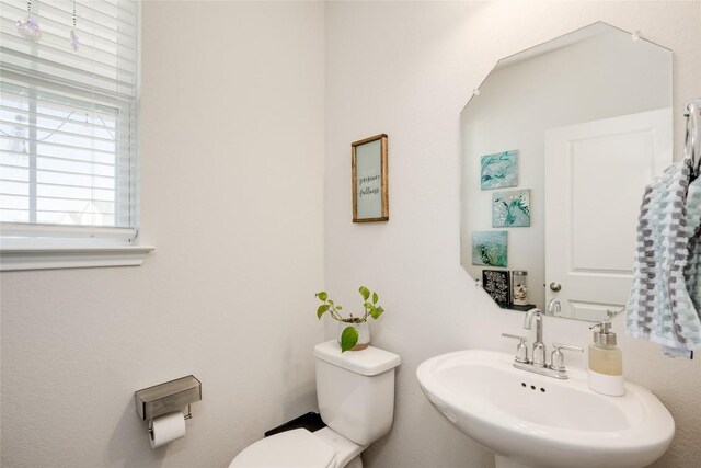 bathroom with toilet and a sink