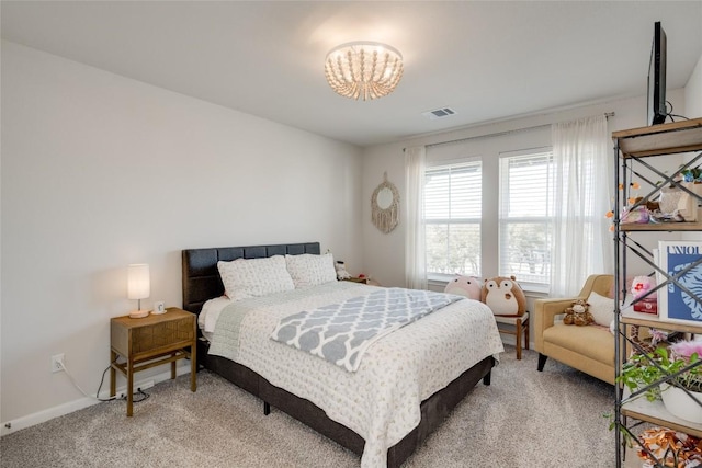 bedroom with visible vents, light carpet, and an inviting chandelier