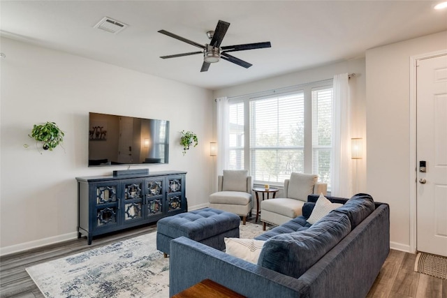 living room with dark hardwood / wood-style floors and ceiling fan