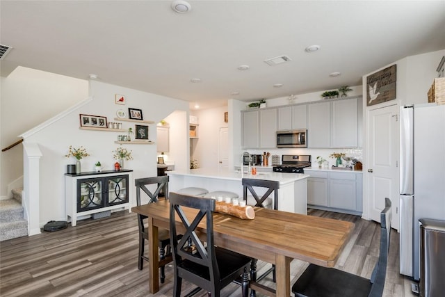 dining space featuring dark wood-type flooring and sink