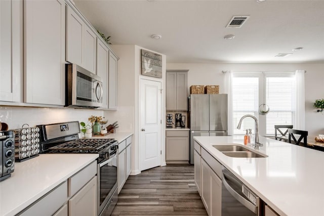 kitchen with sink, dark hardwood / wood-style floors, and appliances with stainless steel finishes