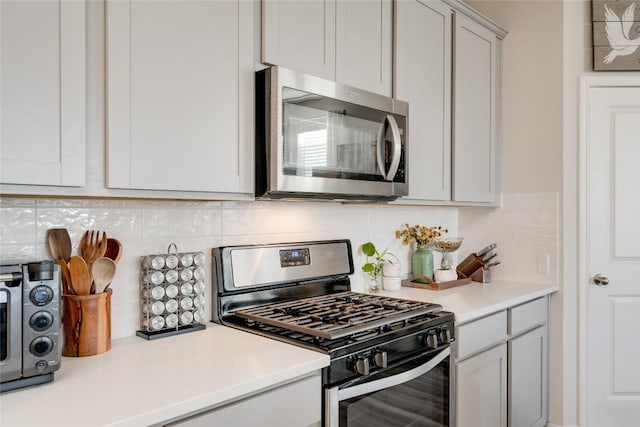 kitchen featuring stainless steel appliances and backsplash