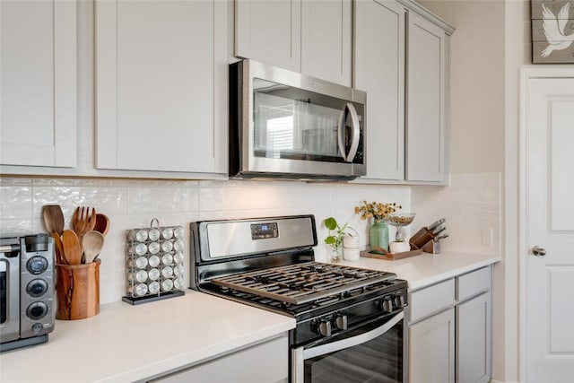 286 Delaware Mountains Ter, Dripping Springs, TX 78620 - kitchen featuring appliances with stainless steel finishes, decorative backsplash, and light countertops