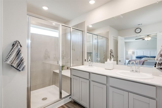 bathroom featuring hardwood / wood-style flooring, vanity, ceiling fan, and walk in shower