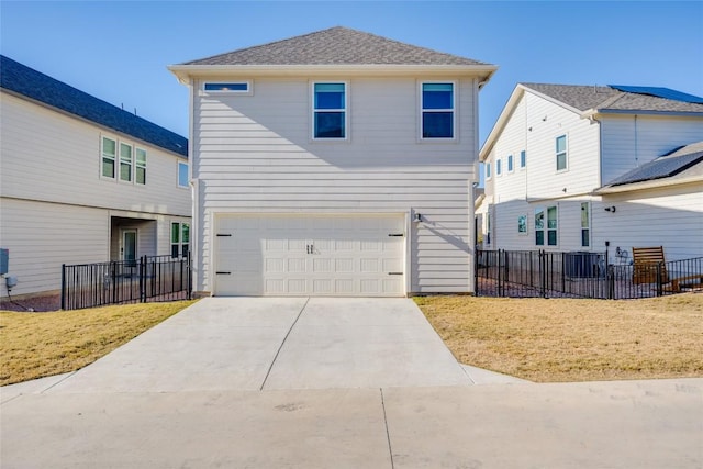 rear view of property with a garage