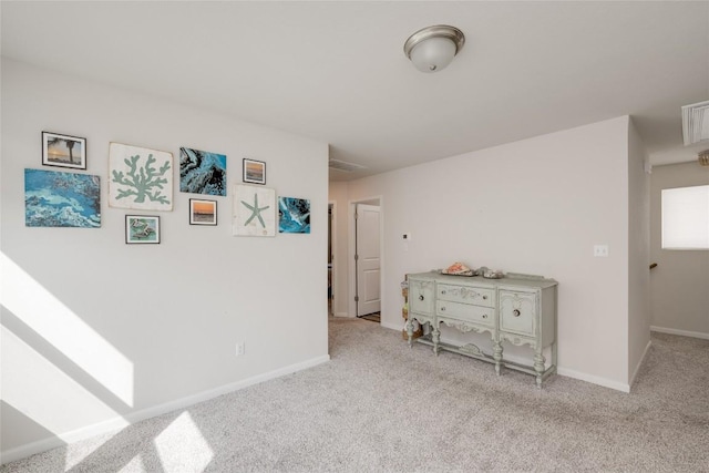 hall with light colored carpet