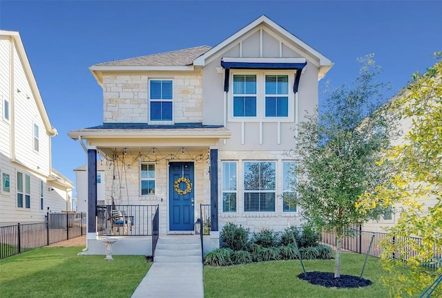 view of front of house with covered porch and a front lawn