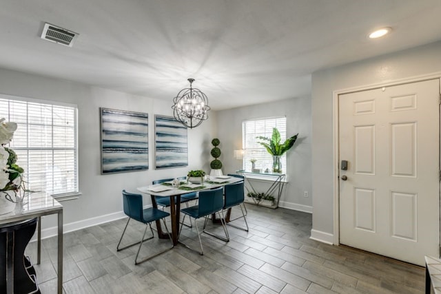 dining area featuring hardwood / wood-style flooring and a chandelier