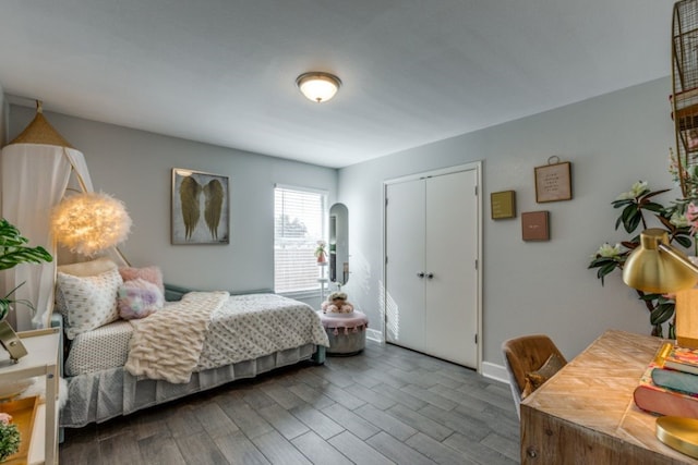 bedroom featuring hardwood / wood-style floors and a closet