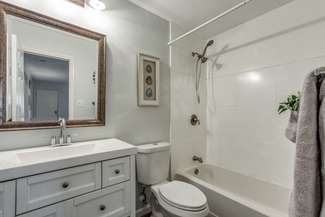 full bathroom with vanity, tiled shower / bath, and toilet