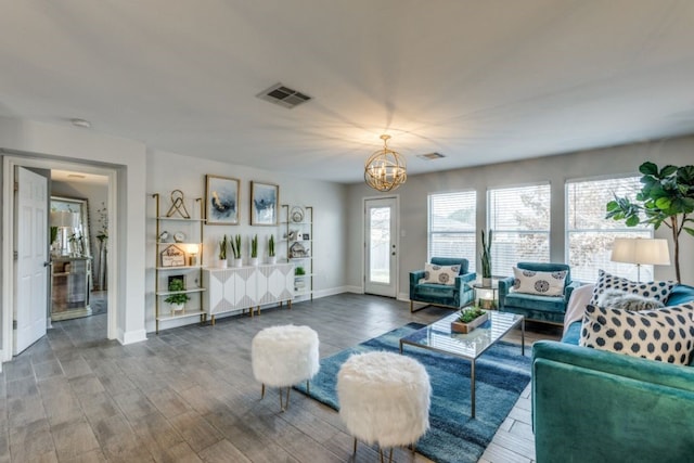 living room with an inviting chandelier and wood-type flooring