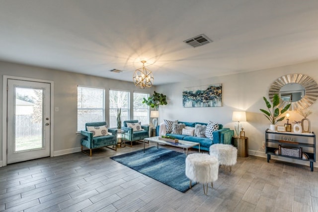 living room with a chandelier and light hardwood / wood-style flooring