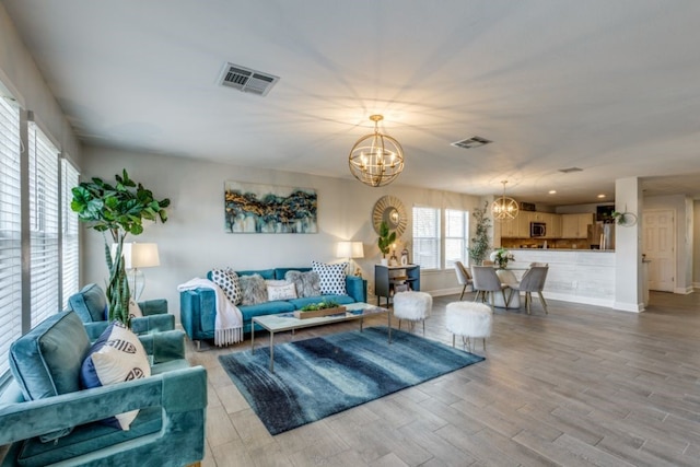 living room featuring light hardwood / wood-style flooring and a chandelier