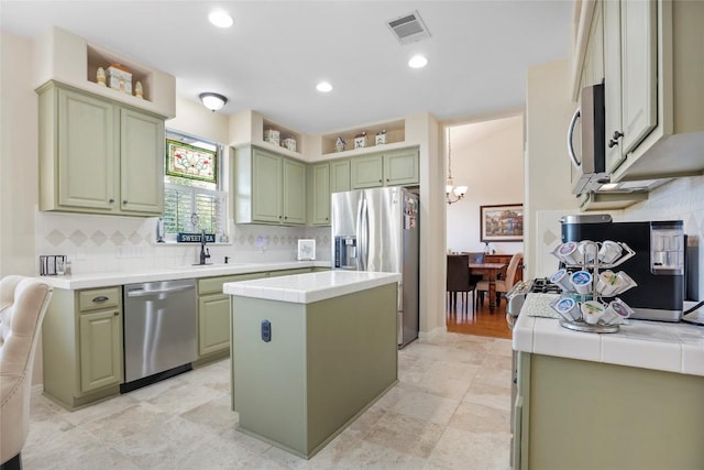 kitchen featuring appliances with stainless steel finishes, green cabinets, and a kitchen island