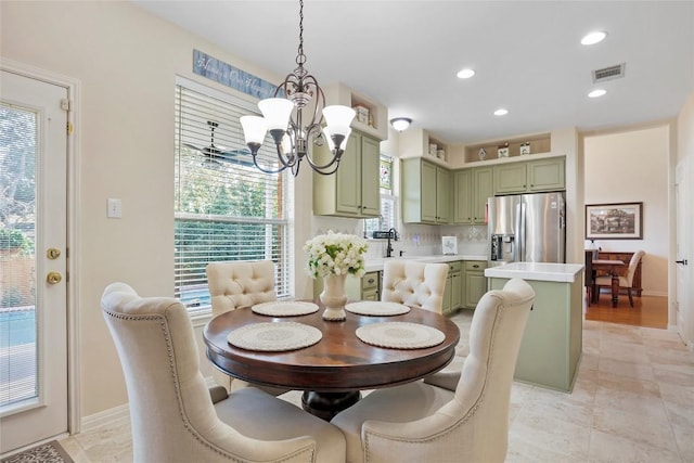 dining space with an inviting chandelier and sink