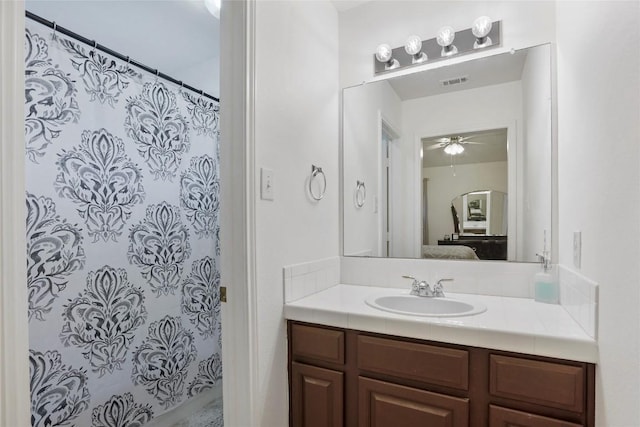 bathroom with ceiling fan, vanity, and curtained shower