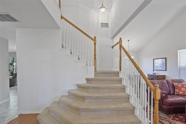 stairs with high vaulted ceiling