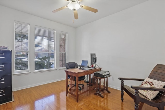 home office with ceiling fan and light wood-type flooring