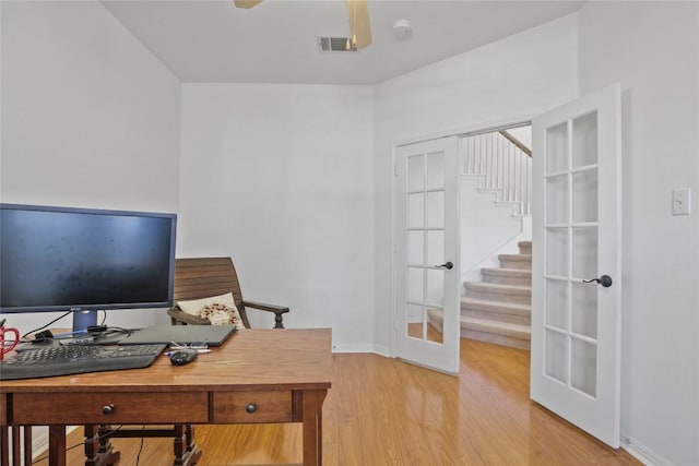 office featuring light hardwood / wood-style flooring and french doors