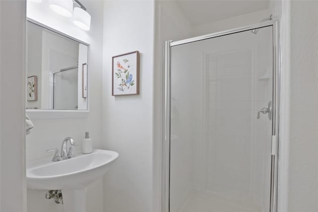 bathroom with walk in shower and sink