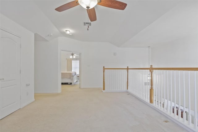 carpeted empty room featuring lofted ceiling