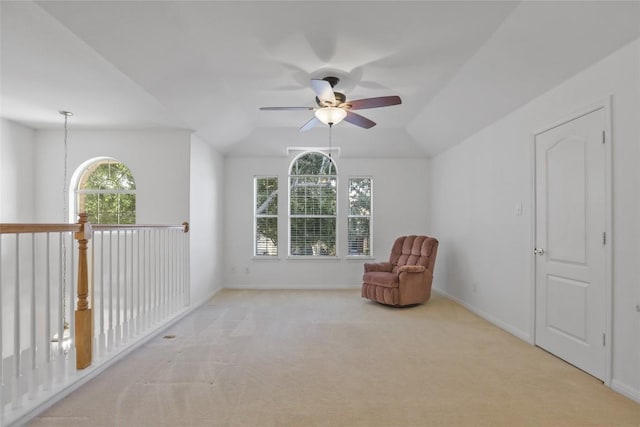 unfurnished room featuring lofted ceiling, light carpet, and ceiling fan