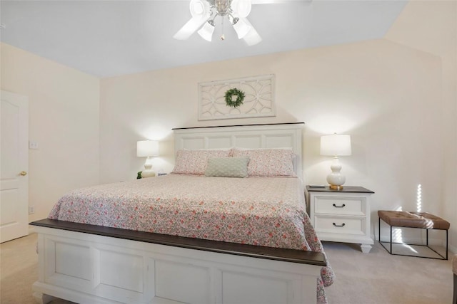 carpeted bedroom with vaulted ceiling and ceiling fan