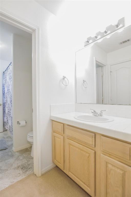 bathroom with vanity and toilet