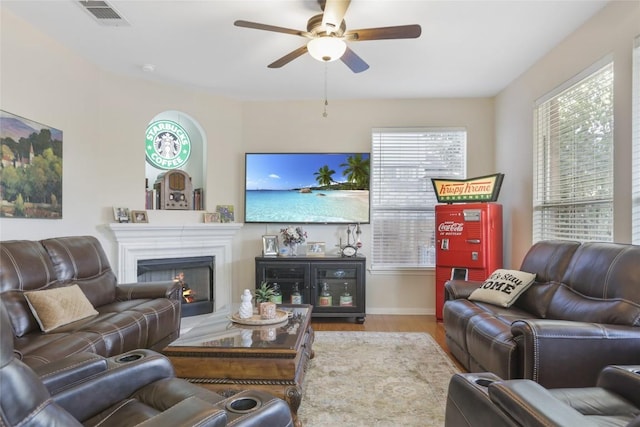 living room featuring ceiling fan and light hardwood / wood-style flooring