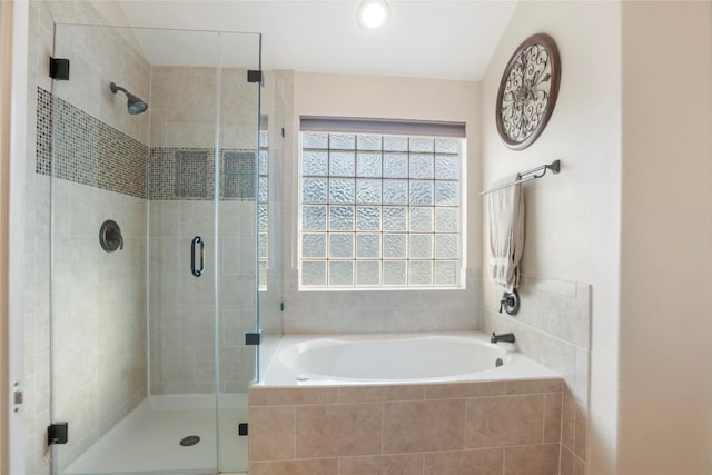 bathroom featuring separate shower and tub