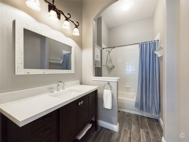 bathroom featuring shower / bathtub combination with curtain and vanity