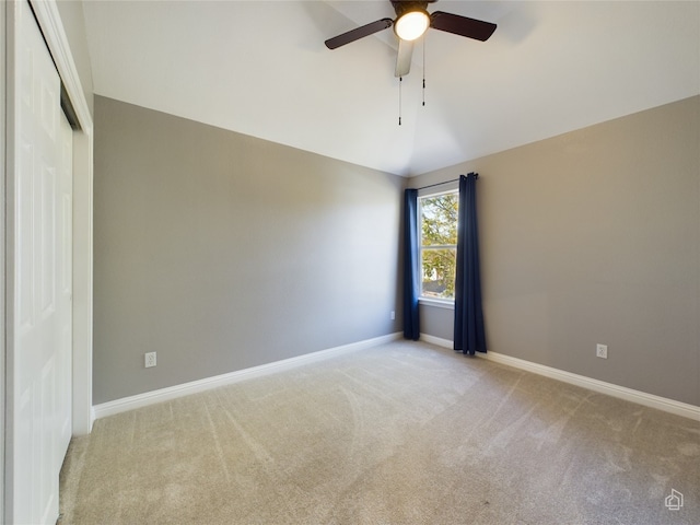 unfurnished room with ceiling fan, vaulted ceiling, and light carpet