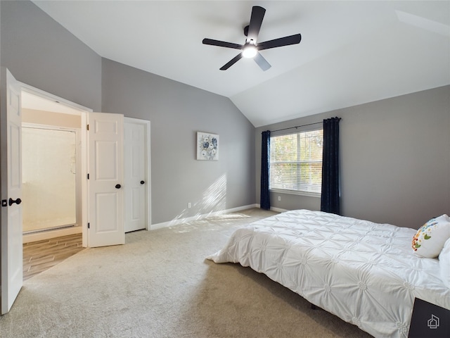 carpeted bedroom with ceiling fan and lofted ceiling