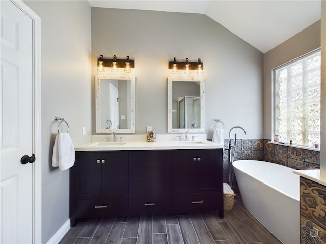 bathroom featuring vanity, lofted ceiling, and separate shower and tub