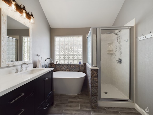 bathroom with lofted ceiling, plus walk in shower, and vanity