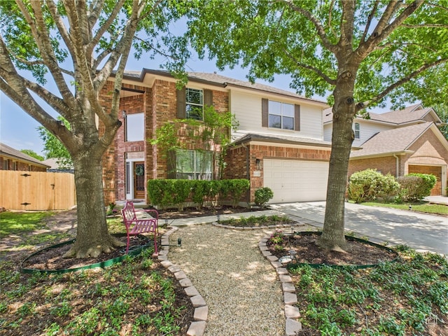 traditional home featuring brick siding, concrete driveway, an attached garage, fence, and a gate