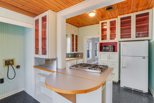 3014 Hemphill Park, Austin, TX 78705 - kitchen with stainless steel appliances, wood ceiling, white cabinetry, light countertops, and glass insert cabinets
