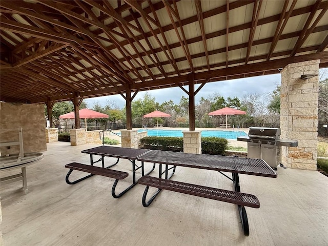 view of community with a gazebo, a swimming pool, and a patio