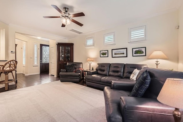 living room with baseboards, visible vents, ceiling fan, dark wood-style flooring, and crown molding