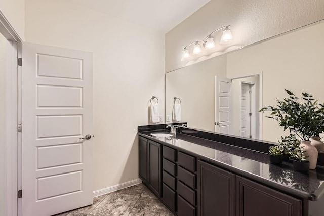 bathroom with vanity and baseboards