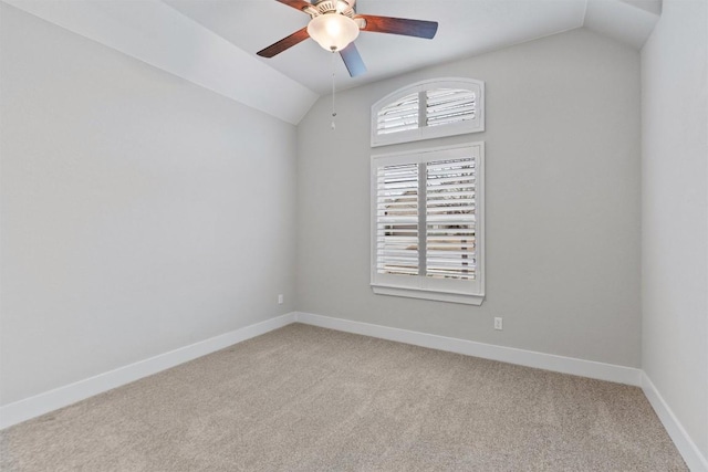 carpeted empty room with lofted ceiling and ceiling fan