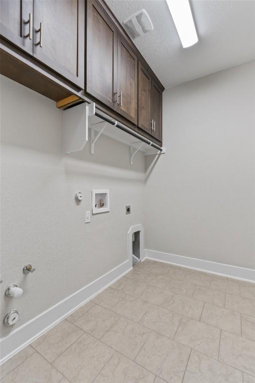 washroom with cabinets, gas dryer hookup, electric dryer hookup, and washer hookup