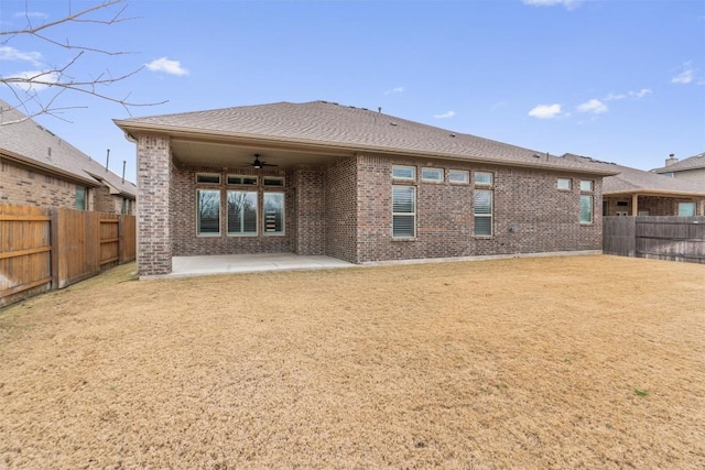 back of house featuring ceiling fan, a yard, and a patio area