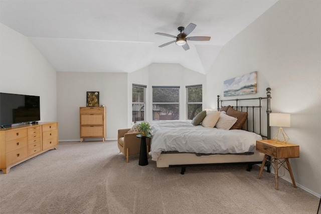 bedroom with a ceiling fan, light carpet, vaulted ceiling, and baseboards